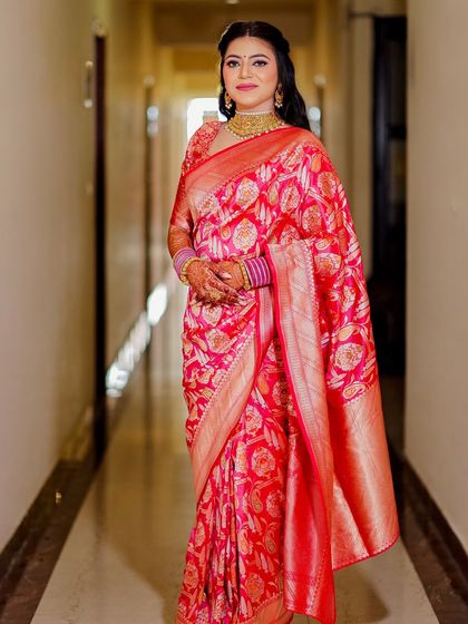 This bride wore a beautiful pink silk saree for her wedding. The makeup was kept soft and elegant to match the humidity of July, and it stayed flawless.