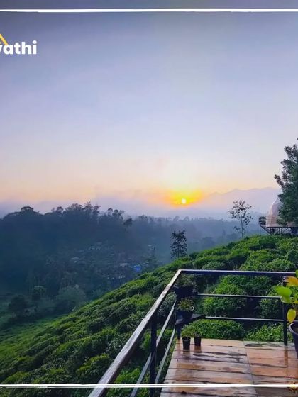 The sun sets over the tea plantations as seen from the deck of a geodesic dome in Wayanad. It's a breathtaking view that makes for an unforgettable evening.