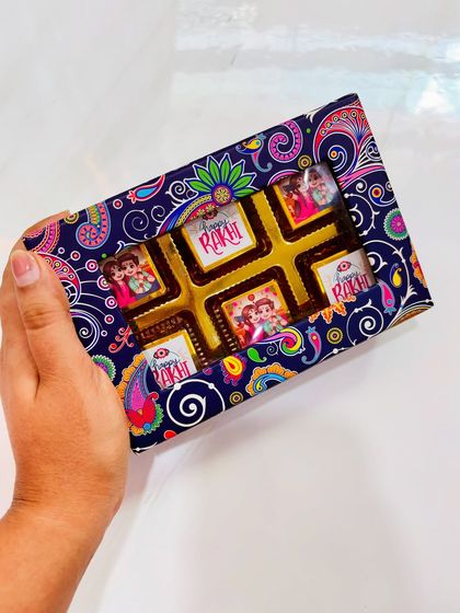 A closer look at the festive Rakhi chocolate box. The paisley-patterned box and custom wrappers make it a beautiful gift on its own or as part of a larger hamper.