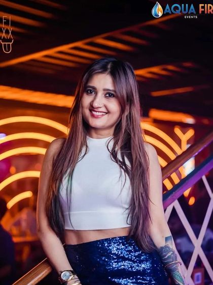 A guest enjoying the stylish ambiance of The Fixx Bar. It's a venue with a great vibe and even better music.