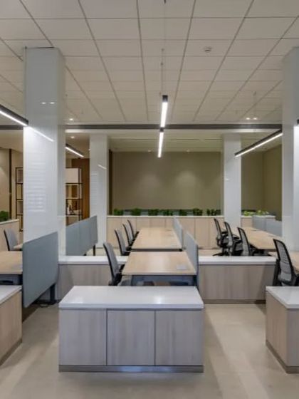 This angle shows the low-profile storage cabinets that also serve as space dividers. This functional design choice keeps the office feeling open and uncluttered while providing ample storage for employees.