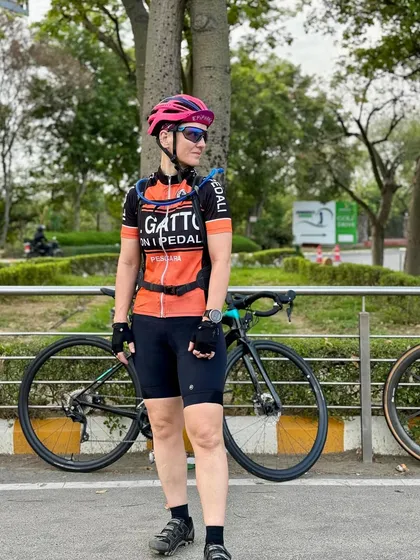 A full-length shot of a rider with her LOOK bike.
