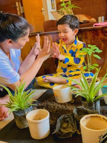 A moment of pure joy as a mother and child celebrate after planting a sapling together. Our campaigns are designed to be engaging and to foster positive connections between family members and with nature.