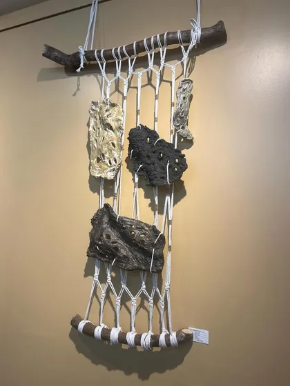 This wall hanging combines macrame with hand-formed ceramic pieces that have beautifully raw, volcanic textures. It's a fusion of fiber and clay art.