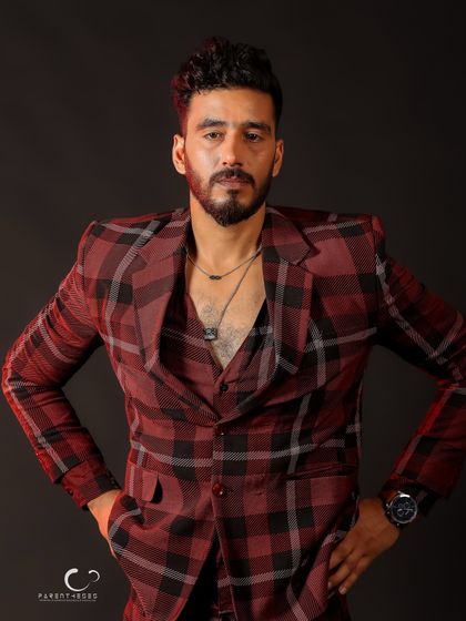 A strong, symmetrical pose that conveys power and stability. The lighting from the side adds dimension to the plaid pattern.