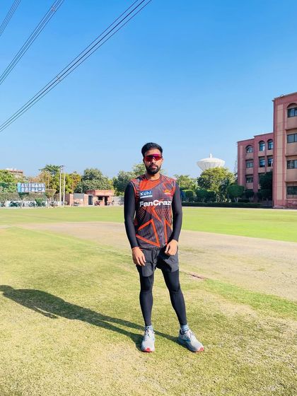 Facing the camera on the training ground. It's about being present, focused, and ready to lead the team through their conditioning work.