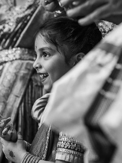 A black and white shot of a young girl watching the wedding ceremony with wide-eyed wonder. We love capturing the reactions of guests, both young and old.