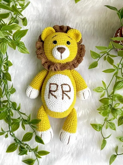 A royal lion plushie, personalized with the initials "RR" on his belly. This majestic friend is ready to rule the playroom with kindness.