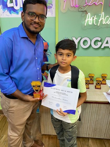 Harshvardhan Kadam is all smiles after receiving his certificate and trophy at the chess tournament.