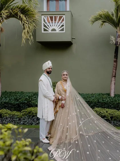 A fairytale begins. This couple's portrait captures the grace and elegance of their wedding day, with the bride's beautiful veil adding a touch of timeless drama.