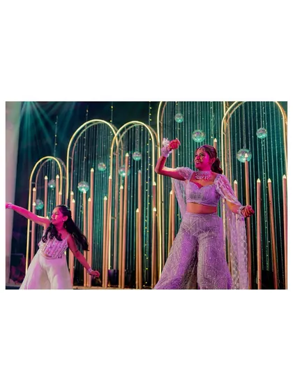 The bride's graceful solo performance on the Sangeet stage. We capture the elegance of her dance against the stunning decor.