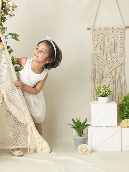 My boho-themed sessions use natural textures like macrame, wood, and greenery to create a calm and earthy setting that beautifully complements your child's simple joy.