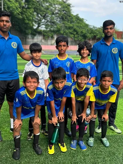 Our U11 team posing with their coaches after a weekend of competitive football.