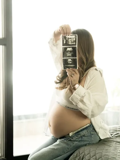 A creative way to include your little one in the portrait, holding the ultrasound photos up to the light.