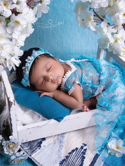 Our little Sakura in blue. The Japanese-inspired cherry blossoms and the beautiful blue lace dress create a unique and culturally rich floral theme.