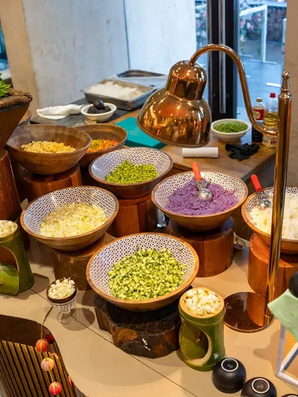 A DIY salad counter with an array of freshly chopped vegetables and toppings. This allows guests to customize their salads to their exact preference.