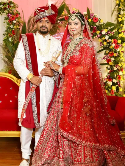 The complete royal look. Her red lehenga, intricate jewellery, and glowing makeup come together for a picture-perfect wedding day style.