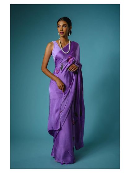 A full-length view of the purple saree, showcasing its modern drape and floral pattern. This is a key shot for any online fashion store.