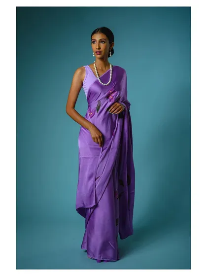 A full-length view of the purple saree, showcasing its modern drape and floral pattern. This is a key shot for any online fashion store.