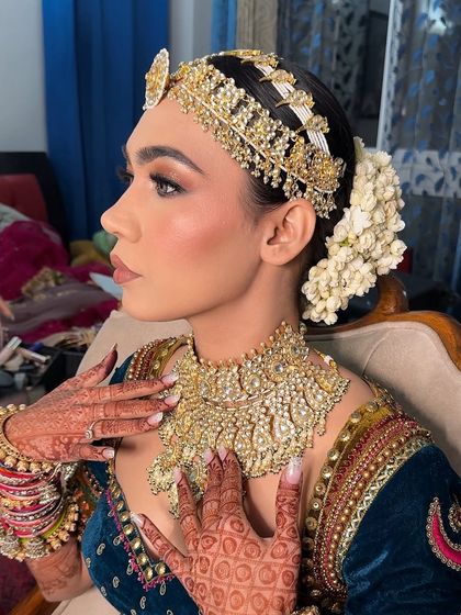 A stunning editorial look featuring a modern, sculpted face and intricate jewelry. This is a perfect example of high-fashion bridal inspiration.