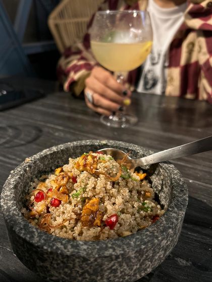 A healthy quinoa salad and a gin cocktail at 145 Cafe & Bar. This shows that a place can have both healthy options and great drinks, appealing to a wider audience.