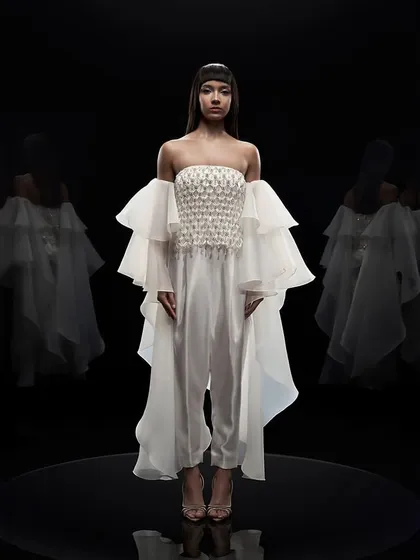 Our studio is equipped for high-end couture photography, where precise lighting control is key. For this Alpana Neeraj campaign, a pure black background and dramatic lighting were used to sculpt the form and highlight the intricate details of the garment.