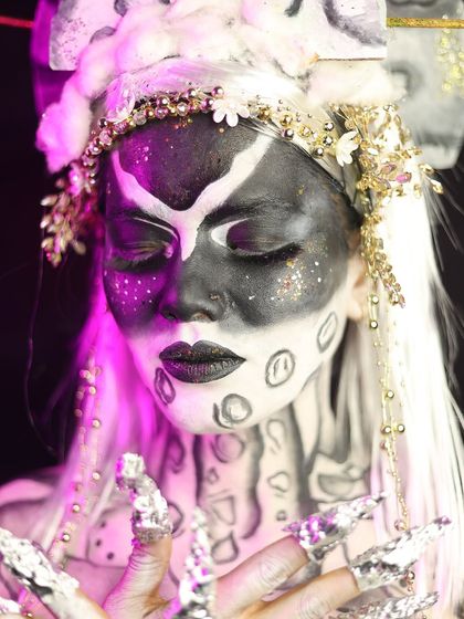 The full look, including a custom headpiece and detailed body art, creating a complete character.