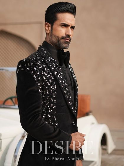 A classic black tuxedo elevated with scattered silver and crystal embroidery on the lapels. This piece is for the man who appreciates timeless style with a touch of modern glamour.
