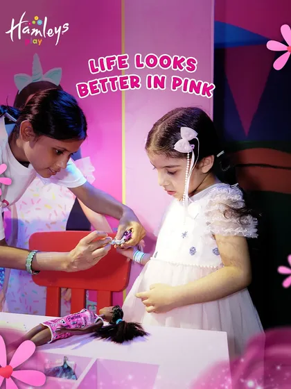 Life looks better in pink at our Barbie's Dream Day event! Here, one of my Play Pals helps a little guest with a fun Barbie-themed craft, part of a day filled with sparkle and creativity.