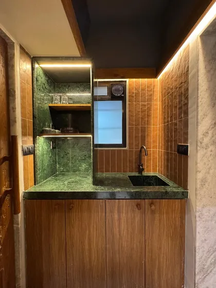 The compact pantry in our studio extension, featuring Baroda Green Marble countertops and open shelving. We used cost-effective, locally sourced Indian marble to add character and depth to this small but essential space.