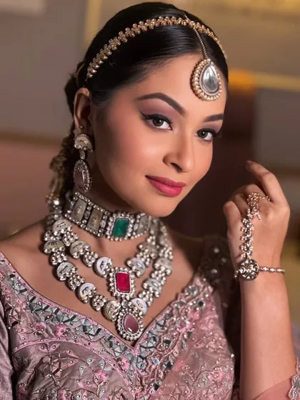 A full view of this stunning party or reception look, complete with intricate jewellery and a sleek hairstyle.