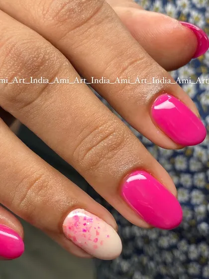 A fun pink set with a paint splatter effect on the accent nail.