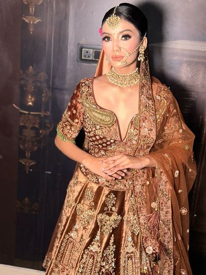 A full view of this stunning bridal look from our shoot. The deep V-neck blouse and rich brown velvet lehenga are perfectly complemented by the radiant, glowing makeup.