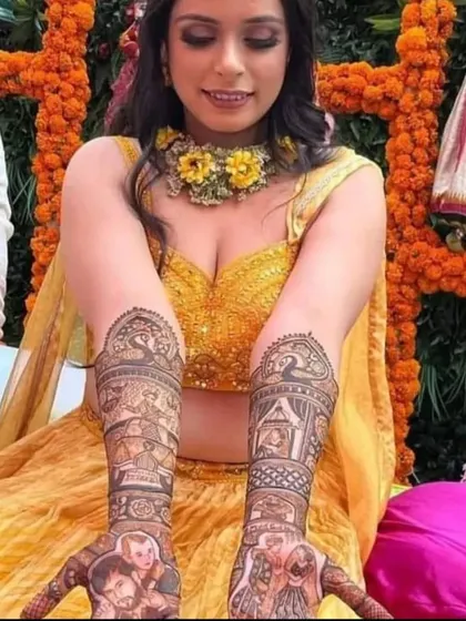 A beautiful shot of a bride showing her portrait mehandi during her haldi or mehandi ceremony.