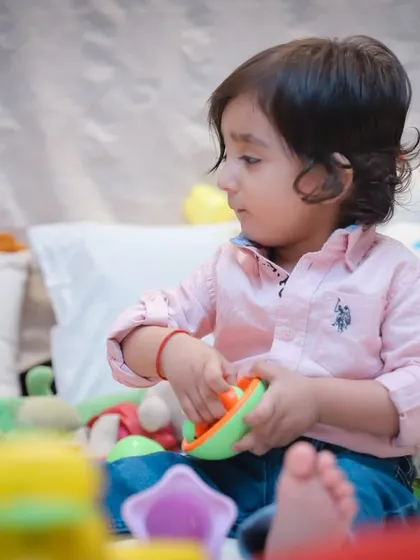 A duplicate image showing the toddler deeply engaged in playtime, a perfect example of our candid photography style.