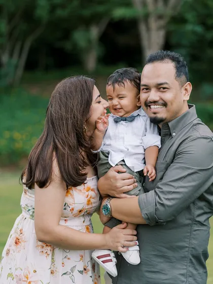 A happy family portrait from the same outdoor session, showing the joy and laughter we captured despite a rainy start.