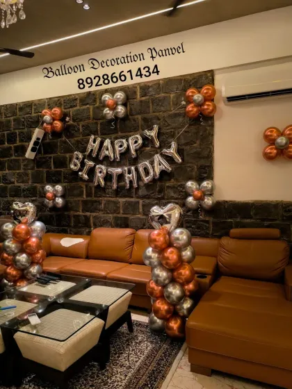 A modern and minimalist birthday decoration using chrome copper and silver balloons. The simple balloon clusters are placed strategically to decorate the living space.