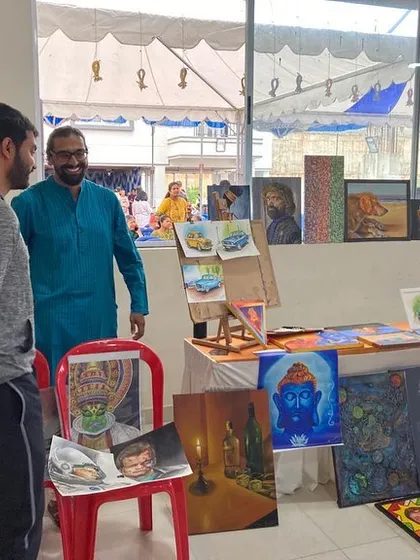 A visitor taking a closer look at my paintings.