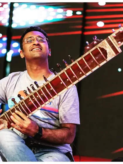 A vibrant shot from a live performance with Parikrama, with dynamic stage lighting. My electric sitar is perfect for high-energy fusion and rock shows.