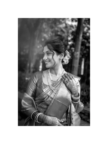 A timeless black and white portrait of the bride. This image highlights her classic hairstyle and the elegance of her pearl jewellery.