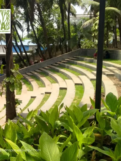 A close-up of the grass-filled steps of the Bandra Fort amphitheater, surrounded by lush tropical foliage. This detail highlights our use of biophilic design principles to soften hardscapes and create a more natural and calming public space.