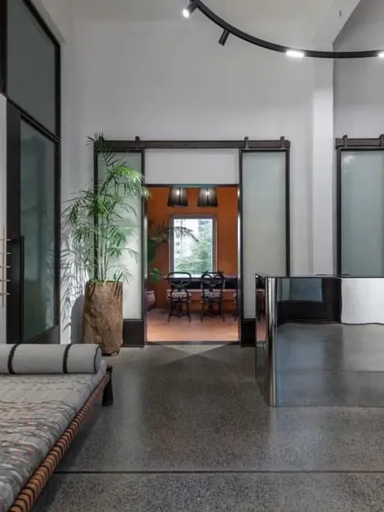 The reception area of the ADND SILO office, with its mirrored desk and industrial-style sliding doors, reflects the firm's ethos of transparency and reinvention.