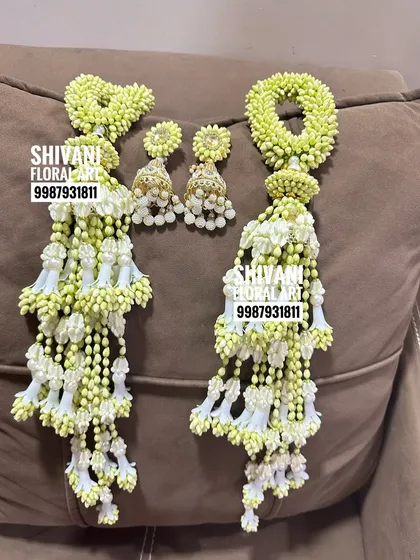 A pair of fresh flower kalire with matching jhumka-style earrings, ready to be dispatched. The intricate work and beautiful finish make them a perfect bridal accessory.
