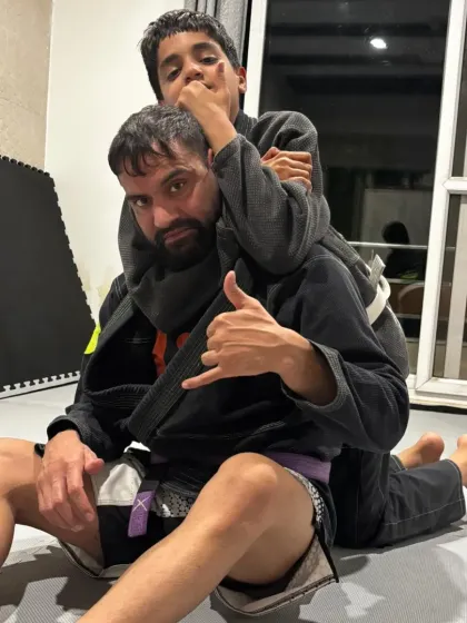 It starts early. Here I am teaching my son the fundamentals of control with a rear-naked choke setup. This is how we build discipline and confidence, right at home.