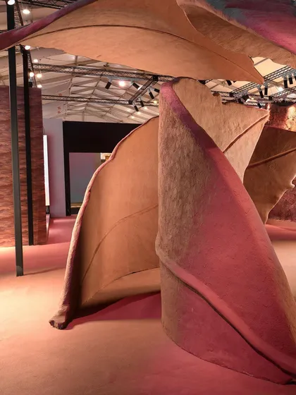 The organic, flowing lines of the 'Terra' leaf sculptures create a dynamic sense of movement within the exhibition space. The forms are designed to feel as if they are still in the process of falling and settling.