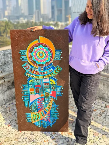 Holding up the 4-foot refurbished panel to show its scale against the Mumbai skyline. This project shows how I can upcycle old items into beautiful, custom interior decor.