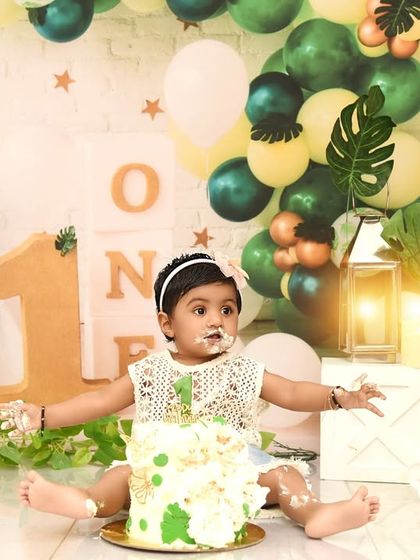 The aftermath of a fun cake smash! This little one is covered in cake and happiness, a perfect way to remember her first birthday.