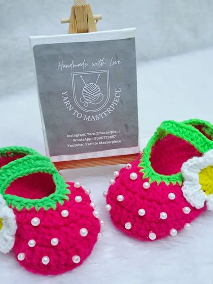 A clear, front-facing view of my popular strawberry-themed booties, showing the green strap, pearl "seeds", and daisy accent.