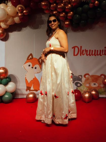 A full-length view of my outfit for a child's birthday party. I always dress to match the fun and festive theme of the event.