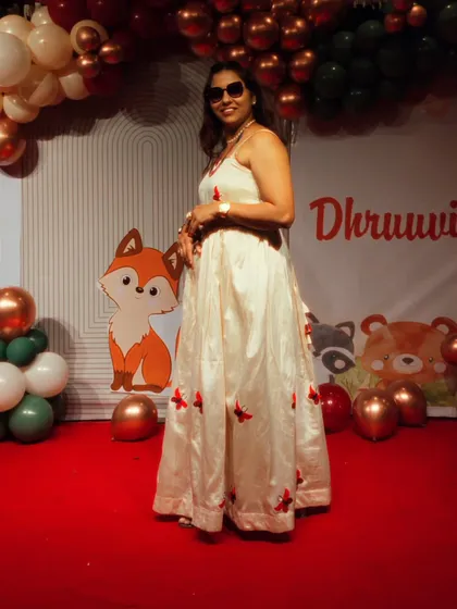 A full-length view of my outfit for a child's birthday party. I always dress to match the fun and festive theme of the event.